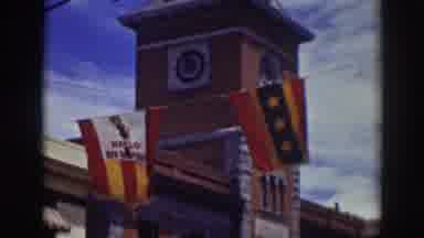 Truckee California (1937): A Medium Sized Building With Two Flags Hanging Off Of