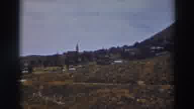 Truckee California (1937): View Of Brown Buildings At Base Of Hill On A Sunny Day