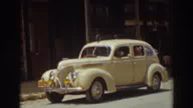 Truckee California (1937): Old Style Yellow Car With A Dog And A Person Inside It