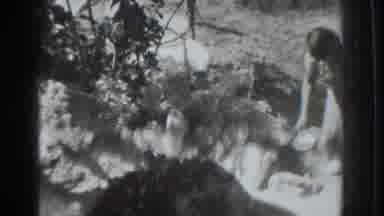 Vacaville California (1937): Woman Holds White Objects To Scoop Substance From