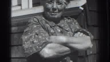 Vacaville California (1937): An Older Woman Speaks To Someone Else With Her Arms