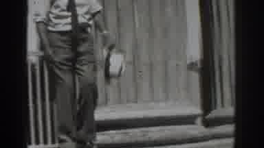 Vacaville California (1937): A Man Holding A Hat Comes Down The Stairs