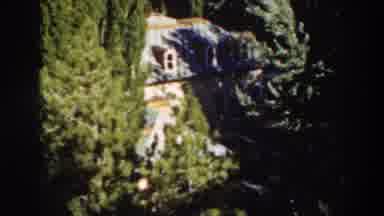 Virginia City California (1937): View Of Blue House And Green Tree On A Sunny Day