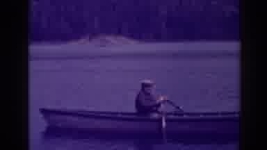 Bucks Lake California (1938): Man Wearing Grey Jacket Rows Boat In Lake On A Clear