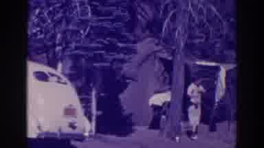 Bucks Lake California (1938): Woman Wearing White Dress Sets Object On Ground