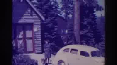 Bucks Lake California (1938): Old Woman Stands Near Yellow Car In Front Of Her
