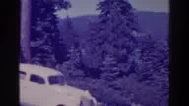 Bucks Lake California (1938): An Elegant Vintage White Car Is Parked In Front Of A