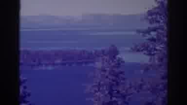 Emerald Bay California (1938): A Lake Surrounded By A Mountain Range And The Tall