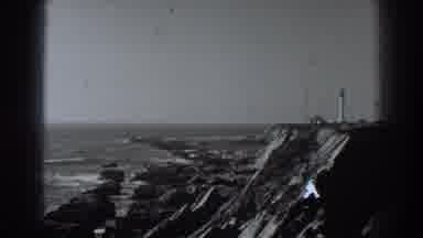 Fort Ross California (1938): A Lighthouse Stands On A Rocky Point Above A Beach