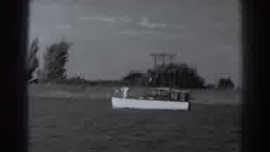 Fort Ross California (1938): A Boat Sailing Slowly In A Lake On A Sunny Day