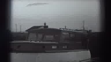 Fort Ross California (1938): The Large Boat Floats Down The River As Man Hangs Off