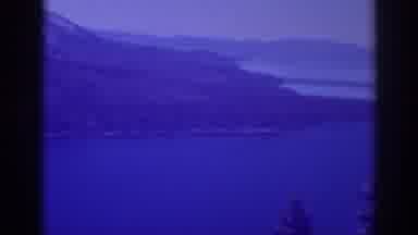 Lake Tahoe California (1938): View Of A Lake In The Mountains Covered In Pine