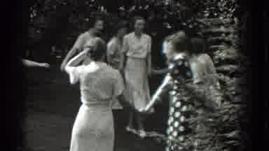 Southhampton New York (1937): Women In Old Fashioned Dresses Hold Hands And Form A