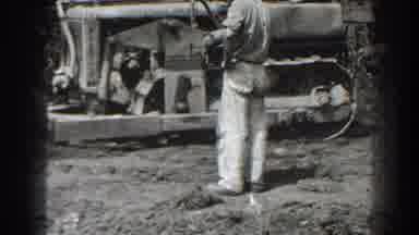 Cumberland Maryland (1938): Man Wearing White Pants Watches Bulldozer On A Clear