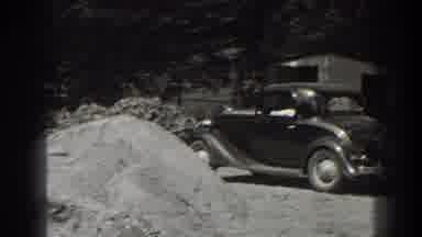 Cumberland Maryland (1938): An Old Car Sitting Beside A Pile Of Sand In A Junkyard