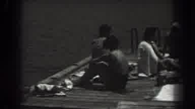 New Jersey (1938): People On Wooden Dock Over Body Of Water One Person On Float In