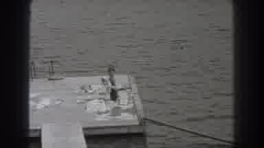New Jersey (1938): Woman Wearing Black Swimwear Smell White Object On Wooden