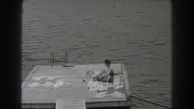 New Jersey (1938): Sunbathing On A Deck Right Over A Lake On A Sunny Day