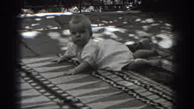 New Jersey (1938): Infant Laying On Mat Swinging Its Feet