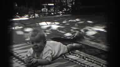 New Jersey (1938): Baby Lying Face Down On The Floor With A Toy In Hands Looking