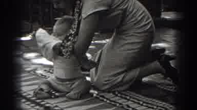 New Jersey (1938): A Woman Kneeling While She Changes Her Baby Boys Shirt