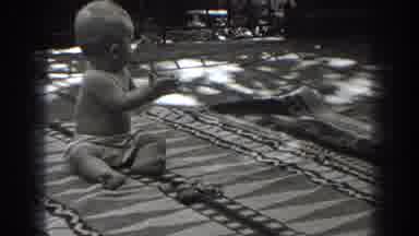 New Jersey (1938): A Baby Sitting And Laying On A Blanket Claps His Hands And