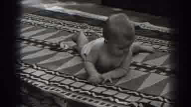 New Jersey (1938): Baby Wearing White Shorts Spins Around On Blanket On A Clear