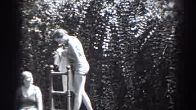 New Jersey (1938): Grayscale Film Of Women Near Ladder In Swimwear With Tall Hedge