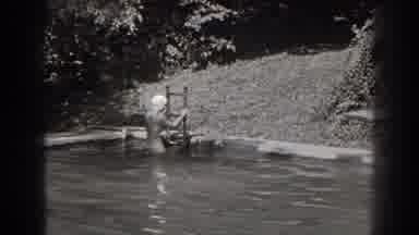 New Jersey (1938): Woman Swimming Pool Trampoline Water Ladder Plants Day Sunlight