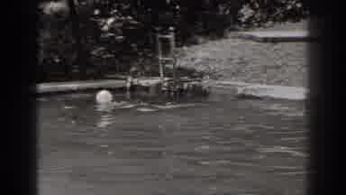 New Jersey (1938): Woman In A Bathing Cap Swimming In A Pool Outdoors