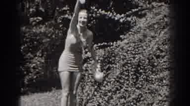 New Jersey (1938): Woman Wearing White Swimwear Waves At Camera On A Bright Sunny