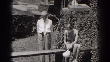 New Jersey (1938): Woman Sitting On A Bench And A Man Standing Next To Her