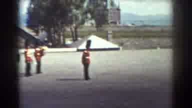 Quebec (1938): Queen Guards Standing On A Line In A Plain Space With A Building On