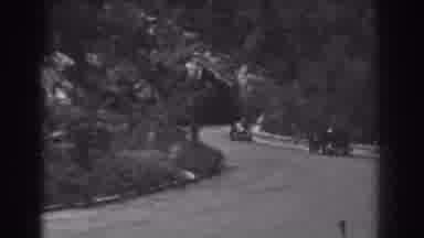 West Virginia (1938): Small Black Car Drives Past Open Gate On A Bright Sunny Day