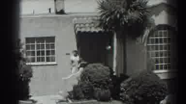 San Francisco California (1939): Camera Panning House Front With Woman Standing At