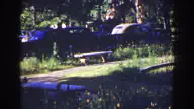 Florida (1941): Two Cars Parked Near Grey Gazebo On A Sunny Day