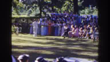 Florida (1941): People Gather In Park To Watch Choir Sing In Formal Clothing At