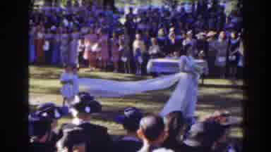 Florida (1941): Girl Holds Train Of Brides Dress While Walking Across Green Lawn
