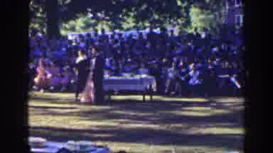 Florida (1941): Woman Wearing Pink Dress Walks To White Table On A Clear Sunny Day