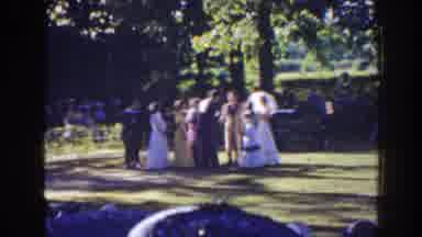 Florida (1941): People Wearing Formal wear Stand On Green Grass On A Sunny Day