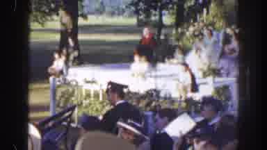 Florida (1941): Woman Wearing White Dress Sits At White Outdoor Table On A Sunny