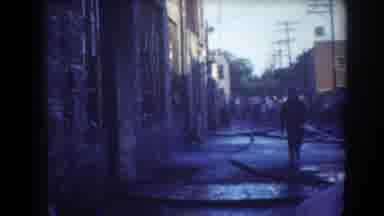 York Nebraska-1958: Man Walking Down A Street During Fire Response