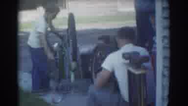 York Nebraska (1958): Father And Children Work On Wheels On Transportation As A