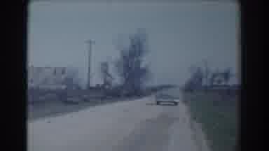 York Nebraska (1958): Vintage Car Driving Down Dirt Road In Daytime Away From