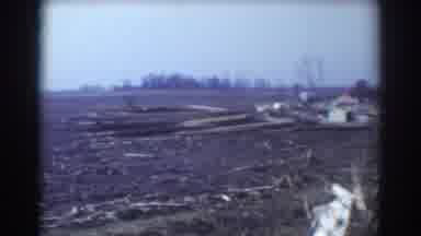 York Nebraska (1958): A Car Passes Damaged Homes And Buildings And A Field With