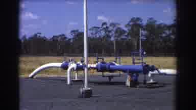Brisbane Australia (1967): White Industrial Pipe Sticks Out From Ground Covered