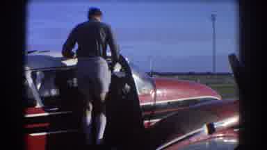 Perth Australia (1967): Older Man Observing A Tall Guy Enter A Small Car As If He