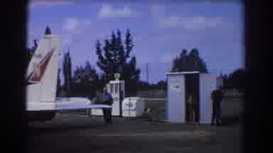 Perth Australia (1967): People Exiting Cars Parked In Airport Behind Airplane