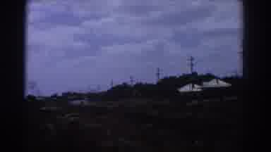 Perth Australia (1967): Pair Of White Buildings Next To Train Tracks On A Clear