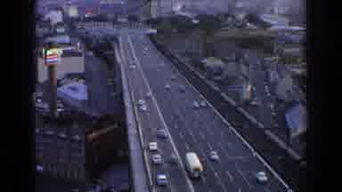 Sydney Australia (1967): Cars And A Bus Driving On A Two-Way Lane Highway In A
